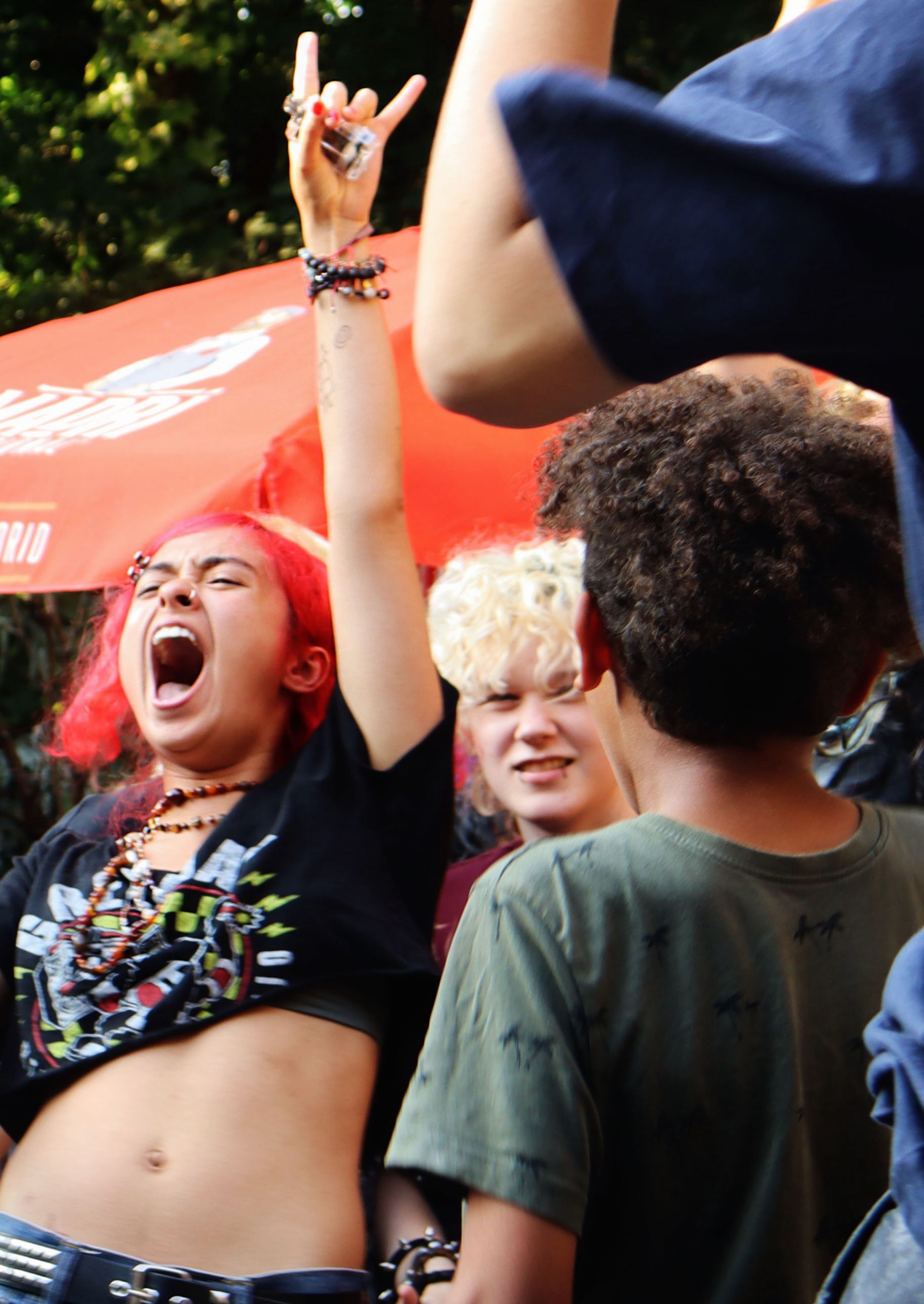 Close-up of a dancer shouting with her arm in the air at an outdoor RUN SY1 event