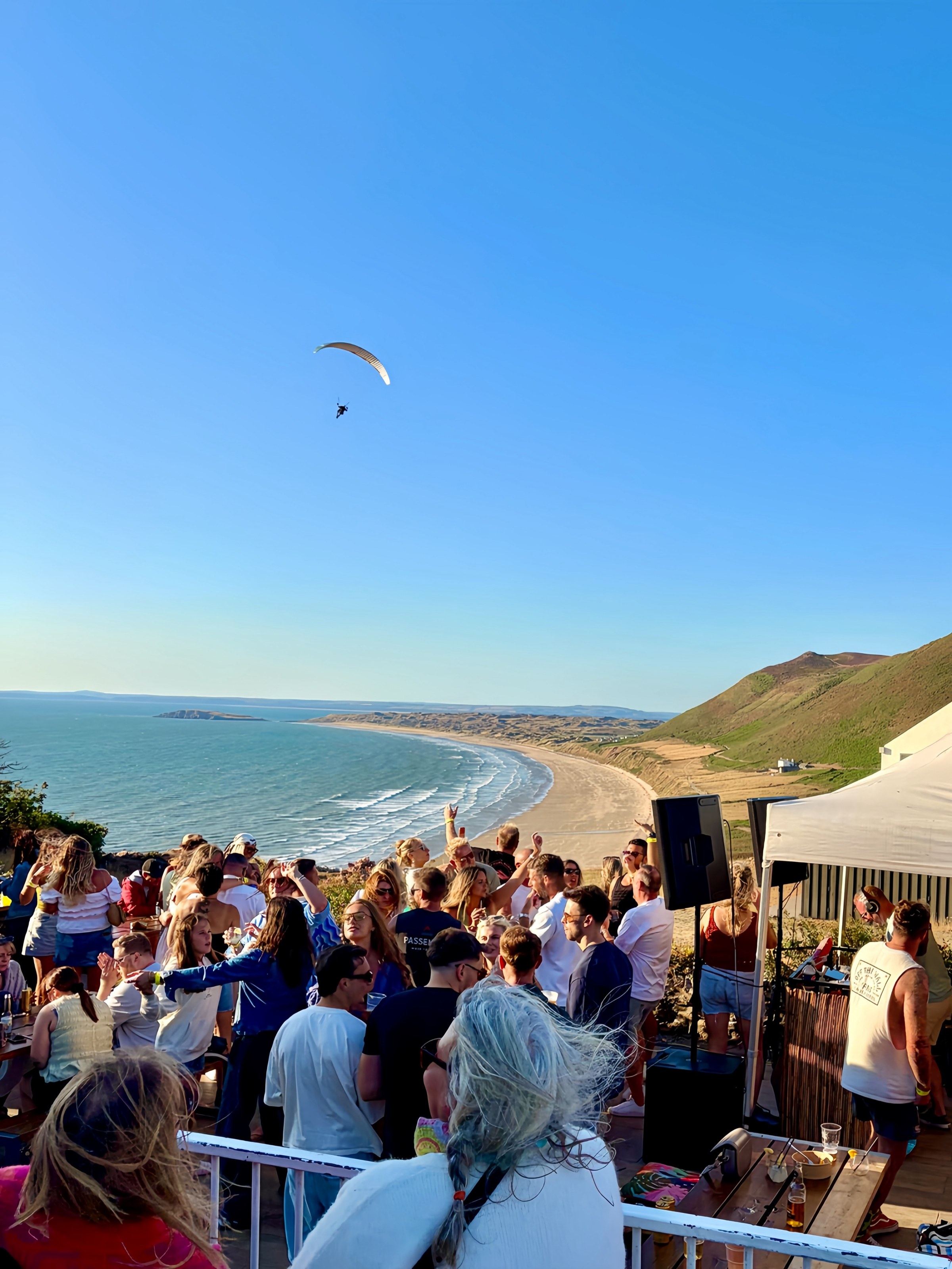 Seasunal Sessions Shoreline Soul at Rhossili, the crowd and DJ tent on the terrace above the beach